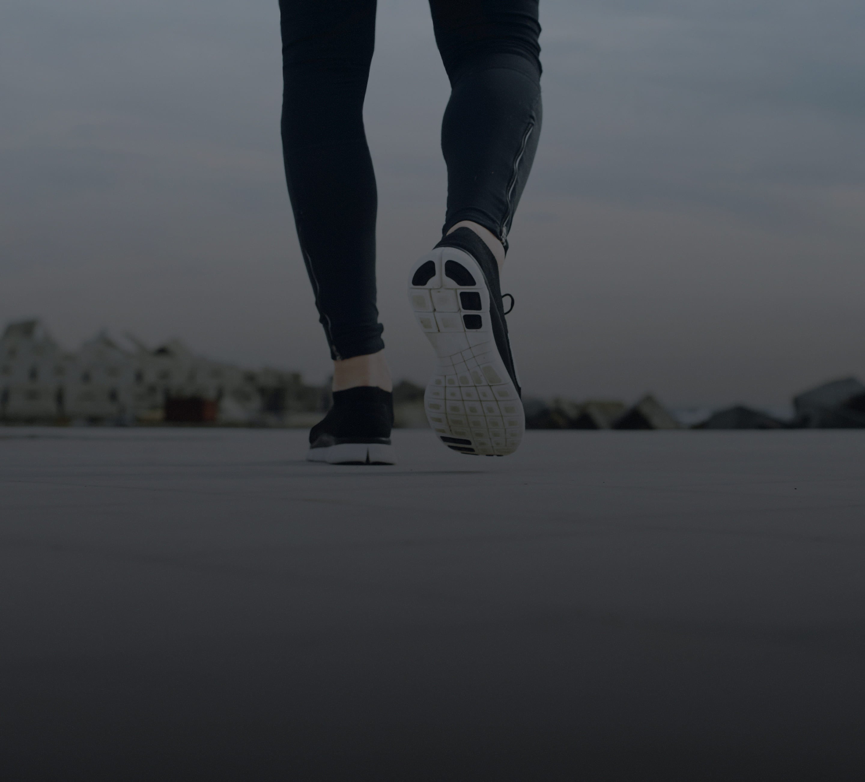 Person running with focus on shoes against a blurred background